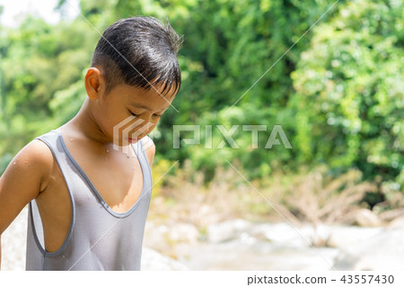 children boy playing near waterfall children boy playing near waterfall 43557430