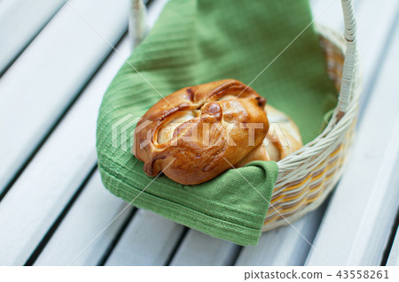 two patties of yeast dough lie in the basket 43558261