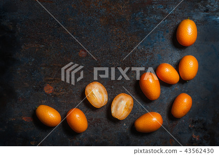 Kumquat fruits on black ceramic plate on a dark ba 43562430