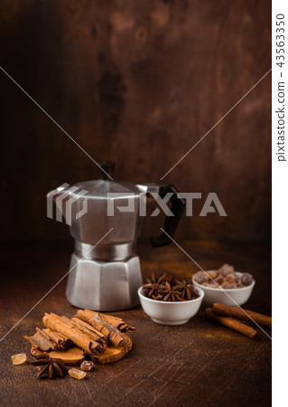Coffee pot with spices on brown background. Coffee pot with spices on brown background. 43563350