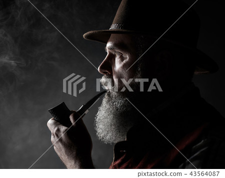 dramatic portrait of senior smoking tobacco pipe dramatic portrait of senior smoking tobacco pipe 43564087