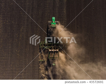Sowing of winter wheat tractor from the air Sowing of winter wheat tractor from the air 43572691