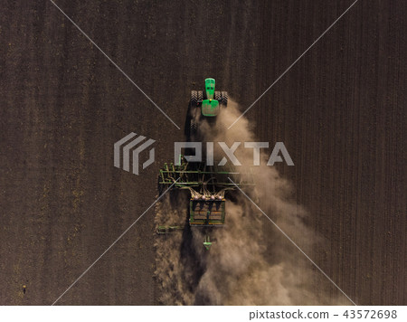 Sowing of winter wheat tractor from the air Sowing of winter wheat tractor from the air 43572698