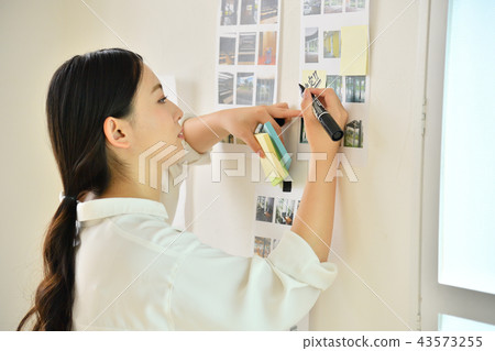 Creative woman writing notes on the wall 43573255