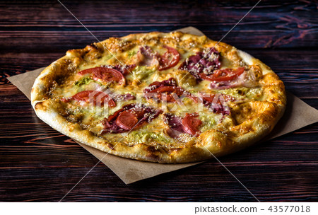 Pizza with a bottle of beer on a wooden table 43577018