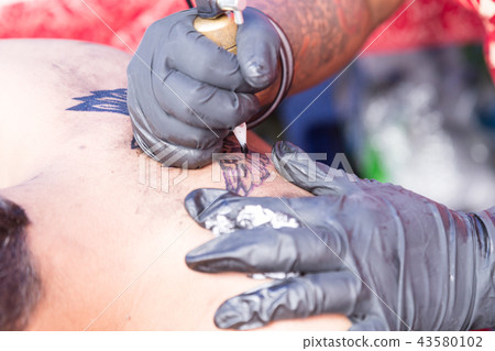 Closeup of permanent tattoo grafting onto body 43580102