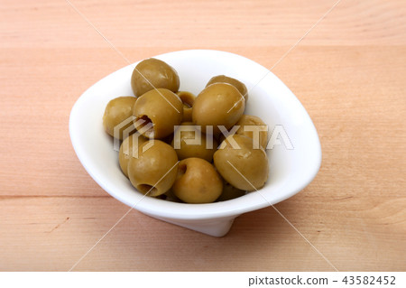 Bowl with fresh olives on wooden background. Bowl with fresh olives on wooden background. 43582452