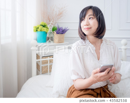 Woman with cell phone Woman with cell phone 43582538