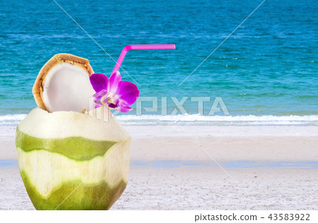 Green coconuts with drinking straw  43583922
