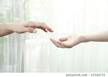  Two people holding hands 43584735