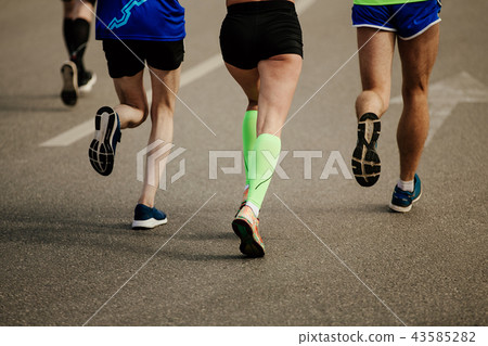 two men and one woman runners 43585282