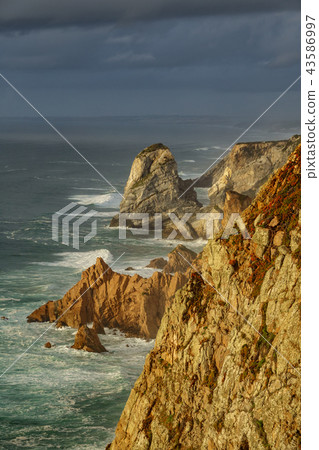 Steep coastline and stormy clouds 43586997
