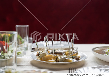 Cheese set with honey and walnuts on festive table 43588750