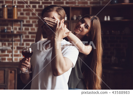 Cute Girl Closing Eyes Guy to Make Surprise Home Cute Girl Closing Eyes Guy to Make Surprise Home 43588983