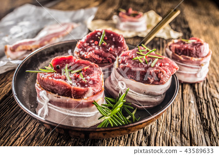 Beef tenderloin steak wrapped in bacon. 43589633