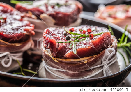 Beef tenderloin steak wrapped in bacon. 43589645