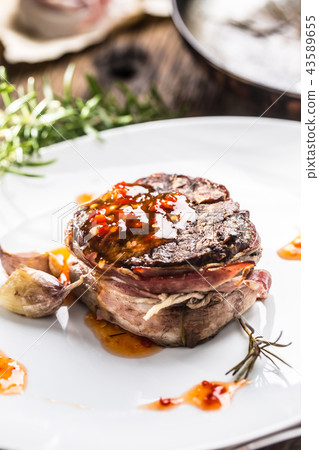Grilled beef tenderloin steak with chili sauce. Grilled beef tenderloin steak with chili sauce. 43589655