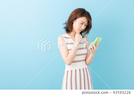 女人看著智慧型手機,思考 女人看著智慧型手機,思考 43593226