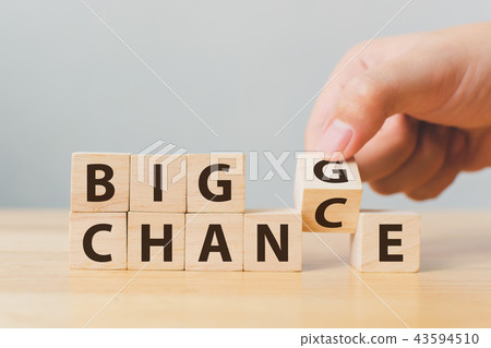 Hand flip wooden cube with word change to chance 43594510