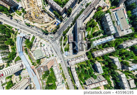 Aerial city view with crossroads and roads, houses, buildings, parks and parking lots. Sunny summer 43596195