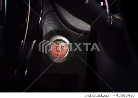 Engine start button of car with a orange light. Engine start button of car with a orange light. 43596456