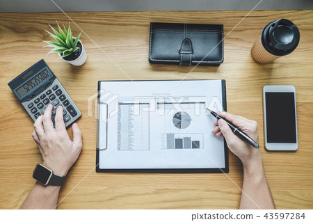 Businessman working on a graph document financial report and ana Businessman working on a graph document financial report and ana 43597284