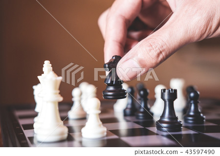 Hand of confident businessman use horse chess piece black playin 43597490