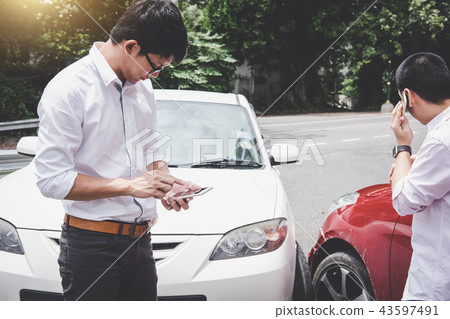 Two drivers man arguing after a car traffic accident collision a 43597491