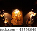 Carved wooden Buddha face, attached to the brown w 43598649