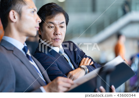 Businessman talking at the airport international airport work Businessman talking at the airport international airport work 43600344