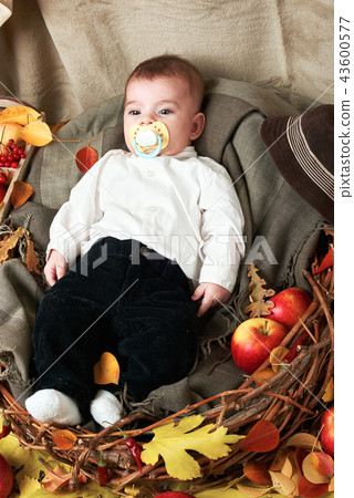 autumn concept - child boy lie on yellow leaves 43600577