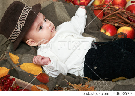 autumn concept - child boy lie on yellow leaves 43600579