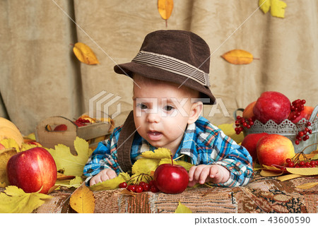 autumn concept - child boy lie on yellow leaves 43600590