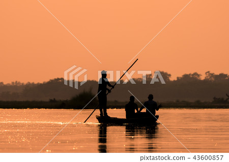Men in a boat on a river silhouette Men in a boat on a river silhouette 43600857