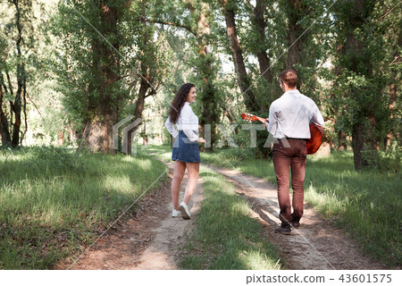 young couple walking in forest, romantic feelings young couple walking in forest, romantic feelings 43601575