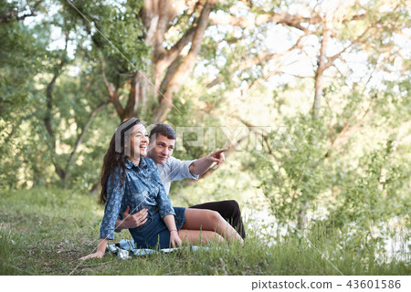 young couple walking in forest, romantic feelings young couple walking in forest, romantic feelings 43601586
