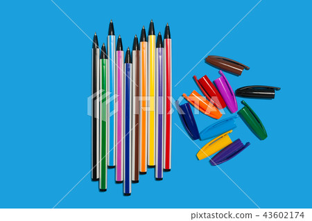 colored pens lying on a blue background without caps 43602174