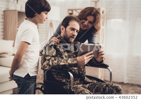 Disabled Man Soldier Watch A Tablet With Family. Disabled Man Soldier Watch A Tablet With Family. 43602352