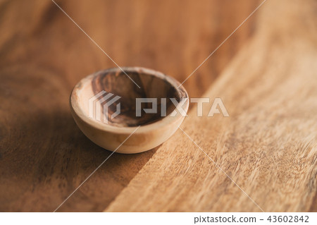 small wooden bowl on wood table small wooden bowl on wood table 43602842