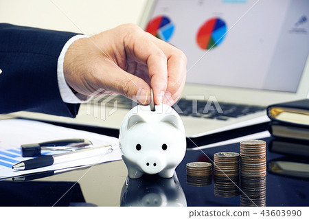 Businessman keep money in piggy bank Businessman keep money in piggy bank 43603990