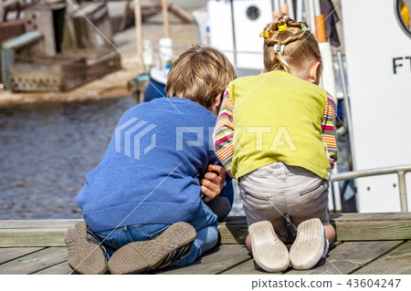 Brother and sister enjoying their vacation in the harbour 43604247