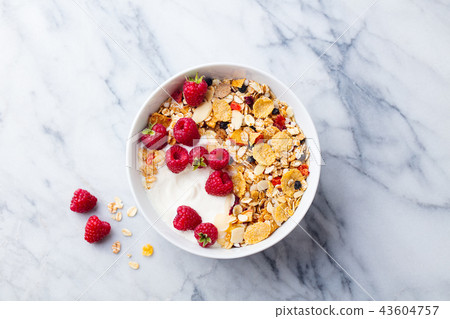 Healthy breakfast. Fresh granola, muesli with yogurt and berries on marble background. Top view. 43604757
