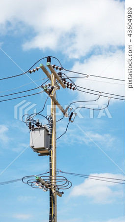 Electric pole and transformer on a blue sky. Electric pole and transformer on a blue sky. 43604989