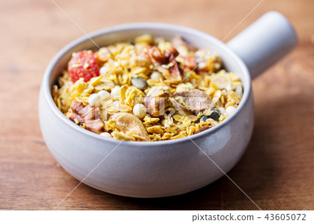 Granola, muesli in ceramic bowl. Healthy breakfast. Organic oats with apples, berries and nuts. 43605072