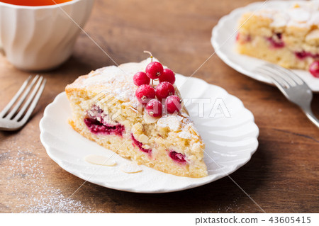 Almond and raspberry cake, Bakewell tart. Traditional British pastry. Wooden background. Almond and raspberry cake, Bakewell tart. Traditional British pastry. Wooden background. 43605415