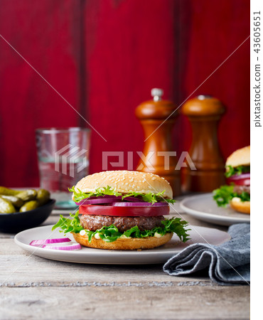 Burger on a plate. Wooden background. Copy space. Burger on a plate. Wooden background. Copy space. 43605651