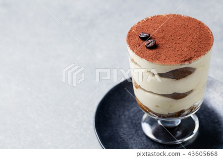 Tiramisu, traditional Italian dessert in glass on a grey stone background. Copy space. 43605668