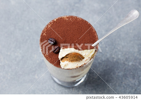 Tiramisu, traditional Italian dessert in glass on a grey stone background. 43605914