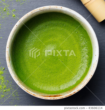 Matcha, green tea latte in a cup. Grey stone background. Top view. Matcha, green tea latte in a cup. Grey stone background. Top view. 43606114