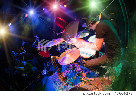 A rock band is playing on stage. A rock band is playing on stage. 43606275